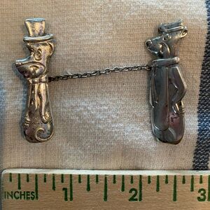 Lapel pin featuring Yogi Bear and Huckleberry Hound.